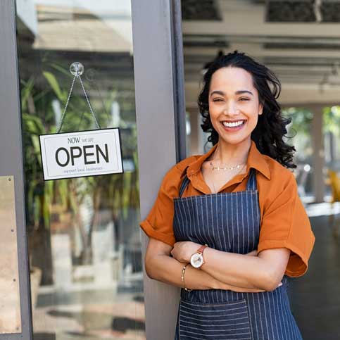 Local business proprietor standing at entrance